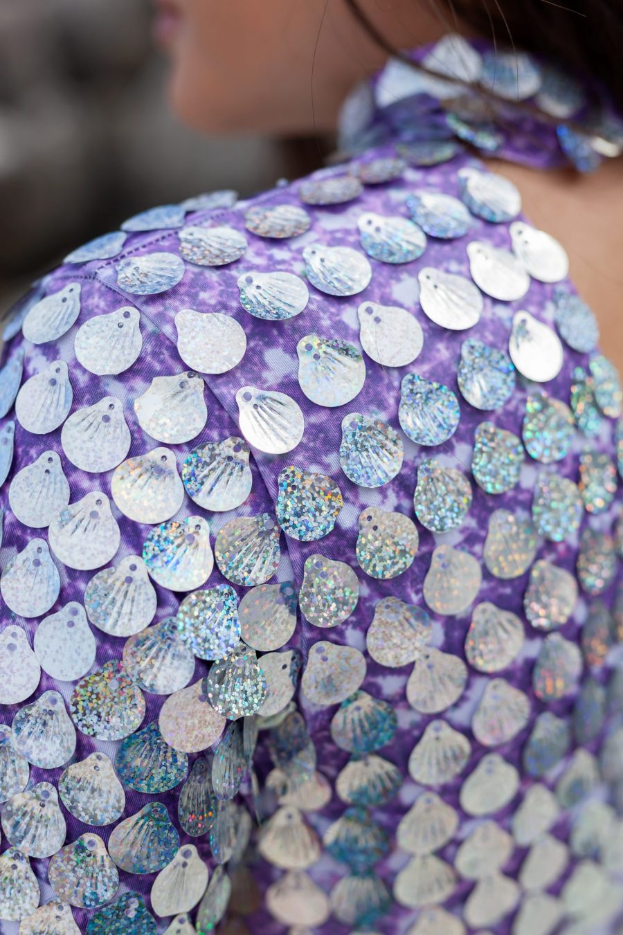 Holographic silver sequin festival dress with light purple fabric underneath, featuring a built-in bodysuit and slightly longer length for a comfortable, elegant fit