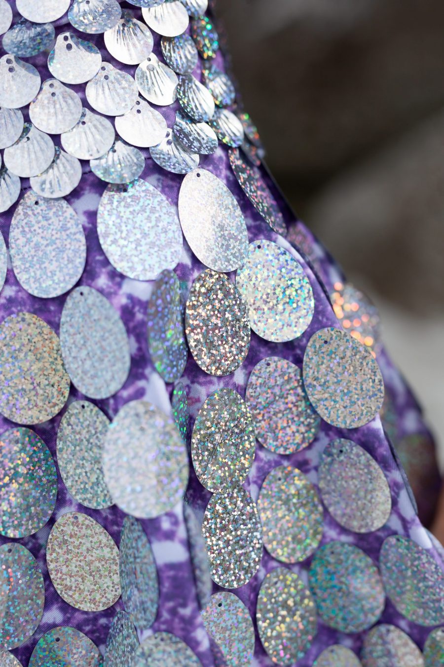 Holographic silver sequin festival dress with light purple fabric underneath, featuring a built-in bodysuit and slightly longer length for a comfortable, elegant fit