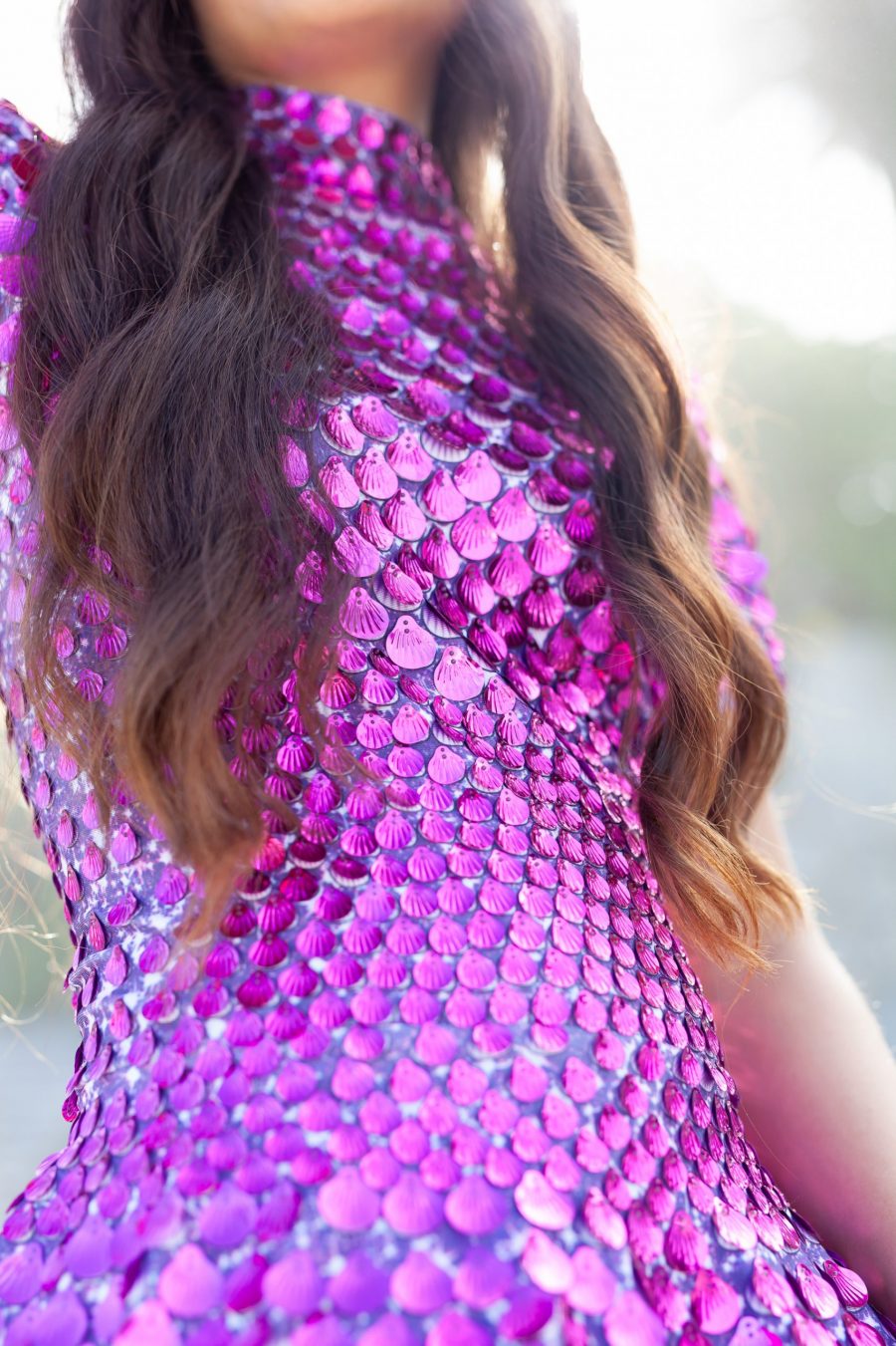 Fuchsia festival dress covered in shimmering shell-shaped sequins, featuring a sleek, mermaid-inspired silhouette and built-in bodysuit for a comfortable, flattering fit.