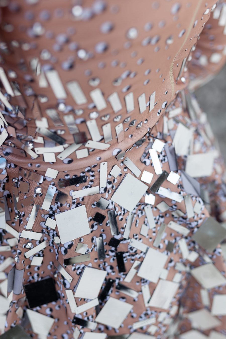 Silver and nude long-sleeved sequin festival dress with a built-in bodysuit, featuring shimmering sequins and a sleek, comfortable fit.