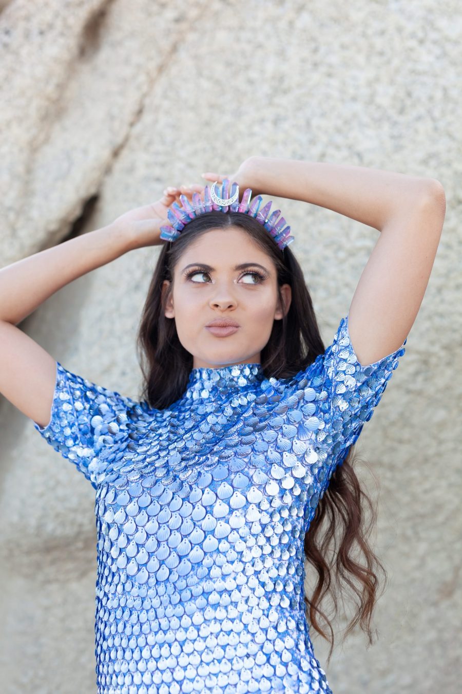 A shimmering aqua blue festival dress covered in shell-shaped sequins, designed with a mermaid-inspired silhouette and built-in bodysuit for comfort. The dress catches the light with every movement, creating a sea breeze effect, perfect for festivals or evening events.
